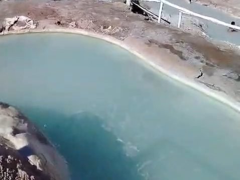Turquoise natural hot spring pool in the Andes, Chile