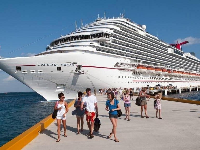 Cruise ship docked at the pier with passengers walking ashore