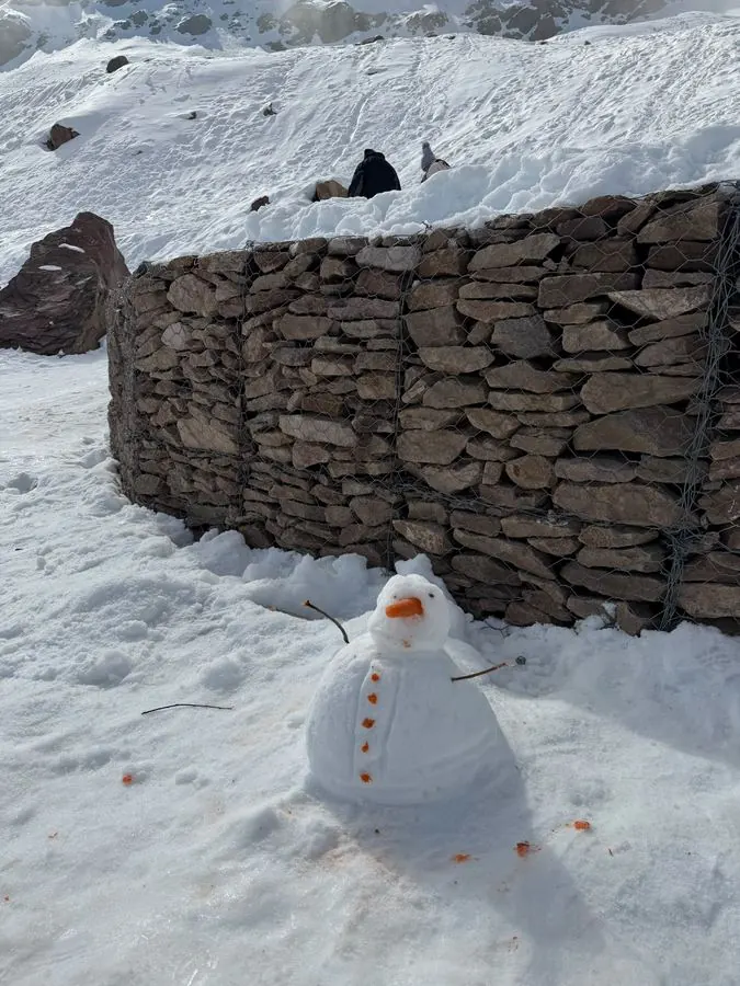 Snowman next to a stone wall in the Andes near Santiago