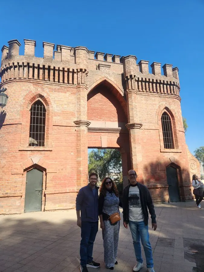Travelers in front of a brick tower on Santa Lucía Hill, Santiago