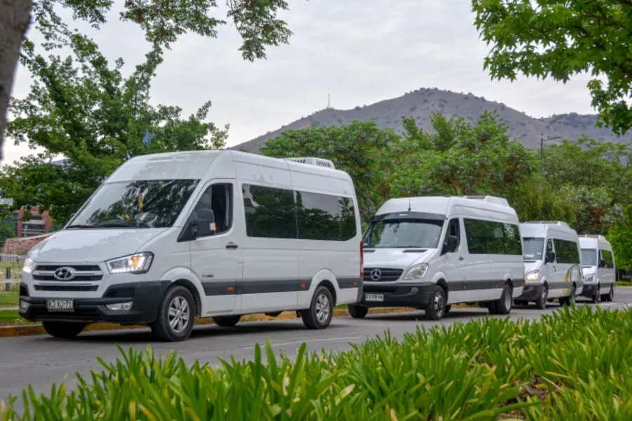 Fleet of white vans and minibuses of Travel Tour en Chile