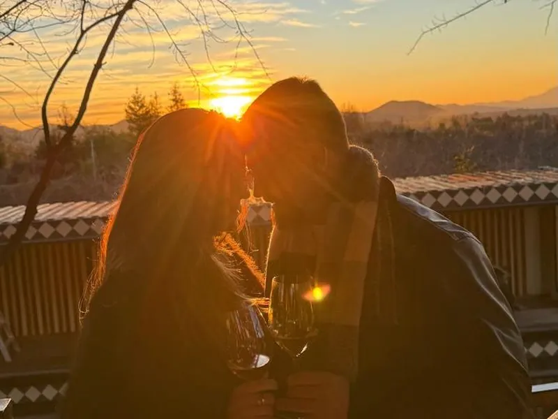 Couple toasting at sunset on a winery terrace near Santiago, Chile