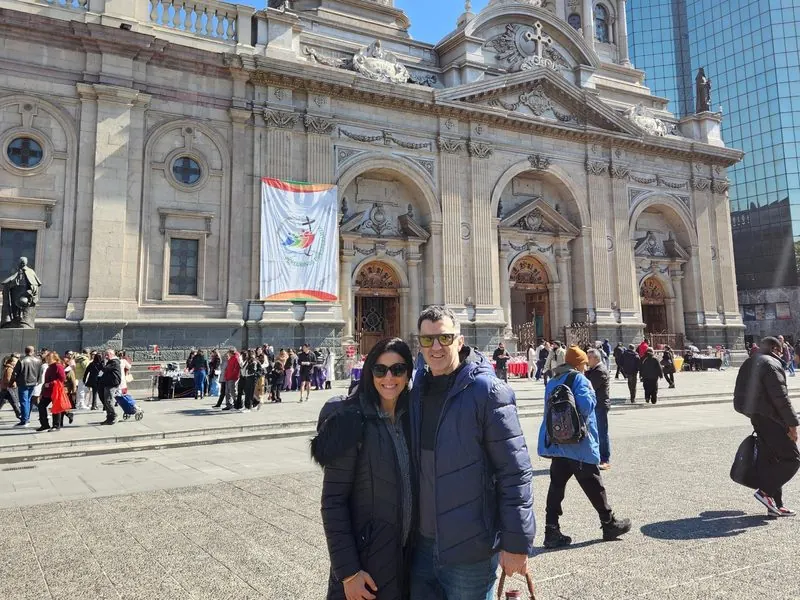Couple in front of the Metropolitan Cathedral in Plaza de Armas, Santiago, Chile